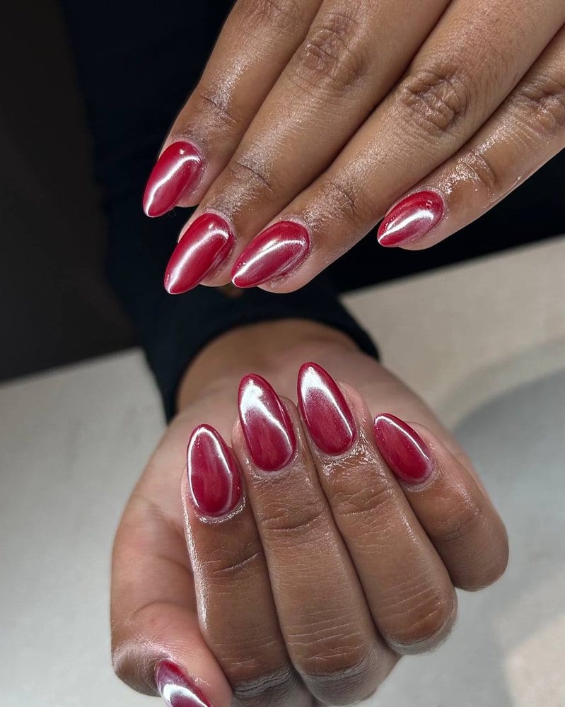 Long almond nails in a mirror-finish cherry red chrome