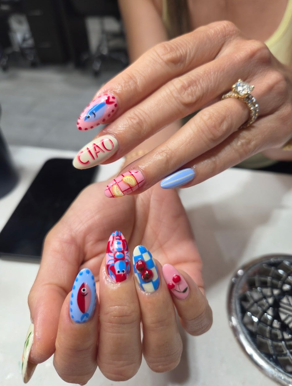 Almond nails hand-painted with an Italian summer scene: CIAO lettering, a lobster, cherries and gingham